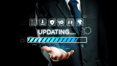 A business professional in a suit holds a digital interface displaying an updating progress bar, symbolizing technological advancement and innovation in modern enterprises.の写真素材