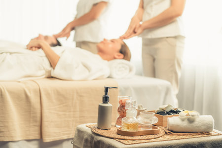 Aromatherapy massage on daylight ambiance or spa salon composition setup with focus decor and spa accessories on blur woman enjoying blissful aroma spa massage in resort or hotel background. Quiescentの写真素材
