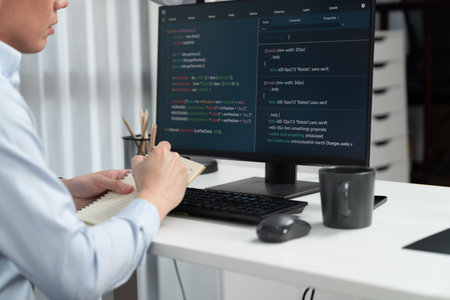 Smart IT developer looking at coding program application on computer screen of online website,...