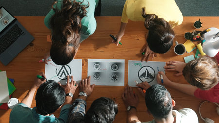 Top view of smart business team put graphic logo on meeting table and start to design while explain...