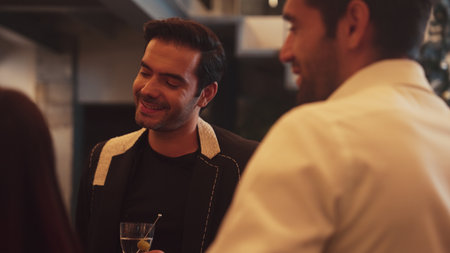 Focusing smart man lively talking with friends while enjoy drinking Martini with olive cocktail at...