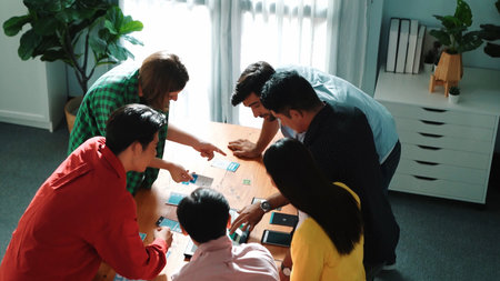 Top view of diverse business people discussing idea and designing system while using tablet with Ux,...