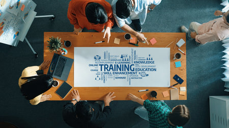 A group of diverse professionals collaboratively engaged in a training session, sharing knowledge...