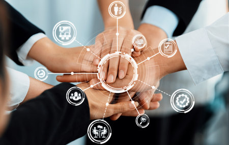 A group of diverse hands join together symbolizing collaboration and teamwork, reflecting management...