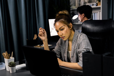 Serious face of thinking businesswoman focusing computer to report data analysis social media online...