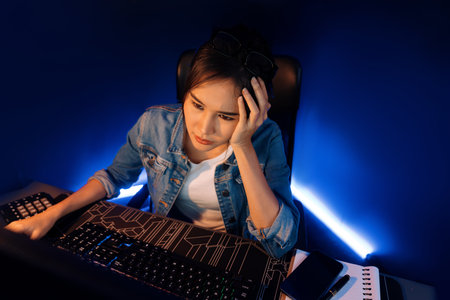 Stressful young beautiful asian creative looking on pc to search project creator social media online...