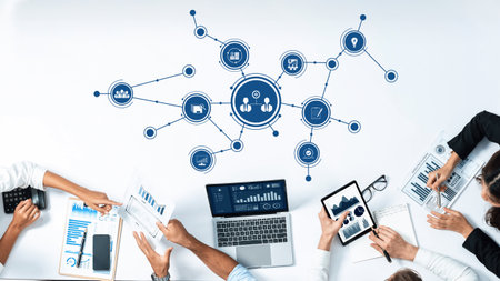 This image depicts a collaborative business meeting where professionals utilize digital tools for...