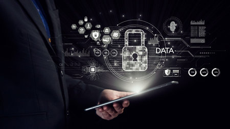 A businessman holds a tablet displaying a digital security interface featuring icons for data...
