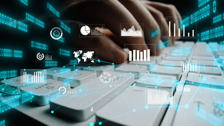This image depicts hands typing on a keyboard with an array of digital data visualization elements....