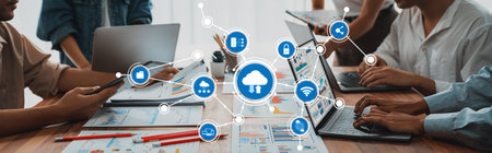 A dynamic workspace showcasing collaboration around multiple laptops and devices. The image captures...