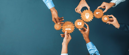 A group of diverse hands holds gears with images representing innovation and technology, showcasing...