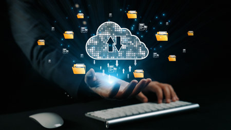 A hand reaches out towards a cloud symbol, surrounded by digital files and folders, illustrating the...