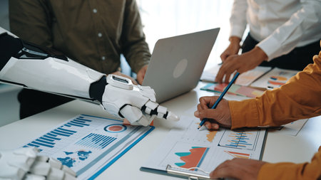 A humanoid robot collaborates with professionals in an office, pointing at data charts and graphs,...