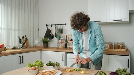 Happy father move to music while cooking food and prepare lunch at modern kitchen. Active dad...
