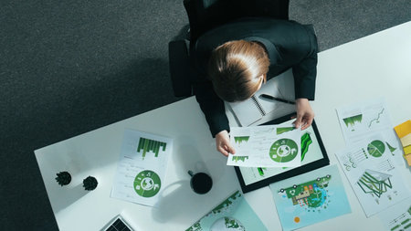 Top view of smart manager making decision about green business investment. Aerial view of skilled...
