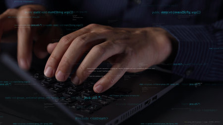 This image captures a close-up view of hands typing on a laptop keyboard, surrounded by digital...