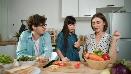 Happy father move to music while cooking food and prepare lunch at modern kitchen. Active dad...
