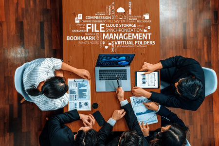 A diverse team collaborates in a modern office environment, analyzing data and discussing file management strategies, enhanced by technology and teamwork. Amityの写真素材