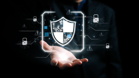 This illustration features a digital shield emerging from a hand, symbolizing cybersecurity and...