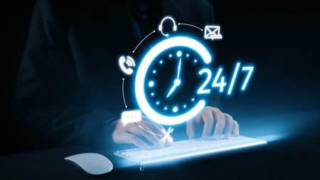 A modern depiction of 24 hour customer service featuring hands typing on a keyboard, illuminated...