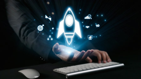 A professional hand holds a glowing rocket launch icon above a keyboard, symbolizing innovation and...