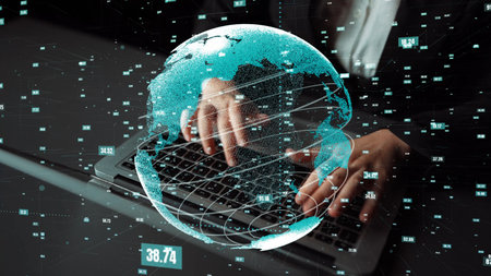 A close-up image showing hands typing on a laptop with a digital globe overlay, emphasizing data...