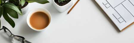 A serene modern workspace featuring a cup of coffee, potted plants, and a notepad. The clean white surface promotes creativity and focus for tasks.の素材