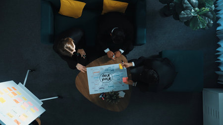 Skilled business man present whiteboard and send sticky notes to manager. Group of smart diverse business team looking and listening presentation while speaker standing at boardroom. Directorate.の写真素材