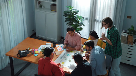 Close up of professional business team hands writing and putting sticky note on scrum task board....
