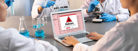 Cyber attacking concept. Malware alert showing on computer screen display scam and threat detection on computer system or online server to be removed brisk.の写真素材