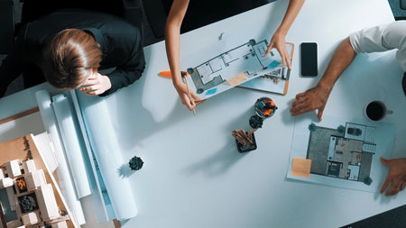 Top down aerial view of project manager walking at meeting table and start working. Aerial view of...