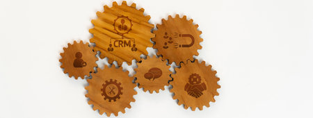 This image features interconnected wooden gears symbolizing collaboration, integration, and the...