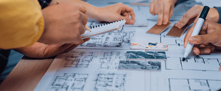 A vibrant scene showing diverse hands engaged in a collaborative design session involving sketches,...