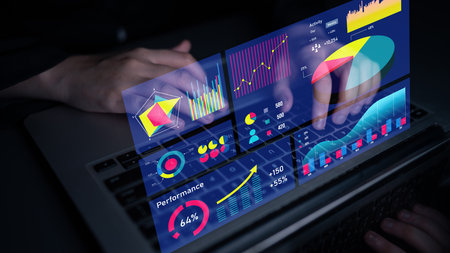 A sleek laptop displays advanced data visualization with colorful graphs and charts analyzing...