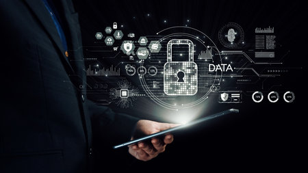 A businessman holds a tablet displaying a digital security interface featuring icons for data...