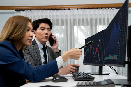 Smiling Asian businessman calling to broker dynamic stock exchange database with woman business...