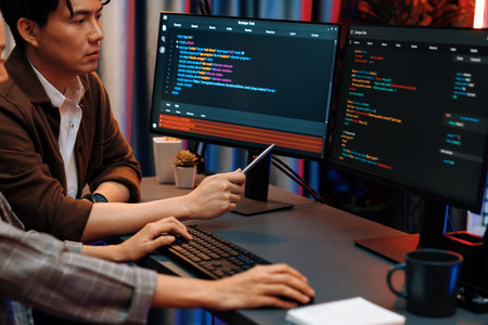 IT developers discussing with point to intelligent website development coder system running data...