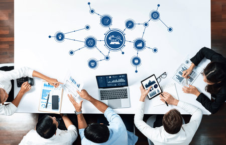 A diverse business team is engaged in a data analysis session, utilizing technology and visual aids...