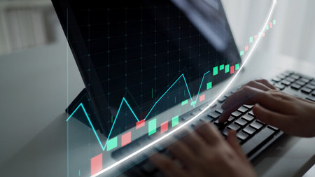 A focused shot of hands typing on a keyboard with a sleek computer screen displaying a vibrant...