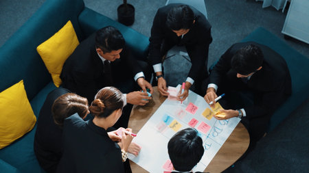 Top view of smart business team write marketing plan and putting stick notes on mind map. Group of happy business people brainstorm financial idea and planning strategy at meeting room. Directorate.の写真素材