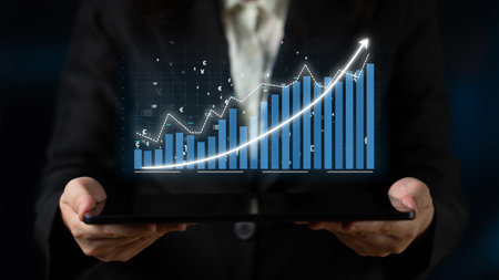 A business professional shows a digital chart with an upward trend on a tablet, symbolizing data...