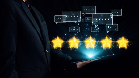 A business professional holds a tablet, displaying five stars above and review bubbles, illustrating...