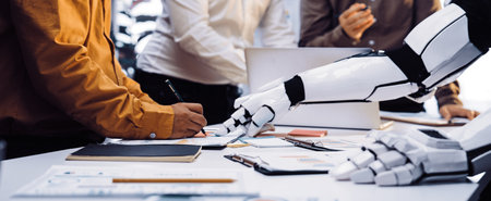 A robot arm interacts with a human in a modern office setting, showcasing collaboration and...