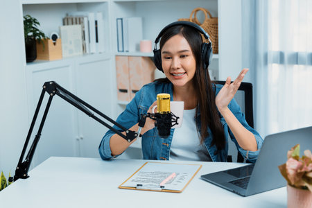 Host channel Asian influencer talking in broadcast streaming online wearing headset on social media...