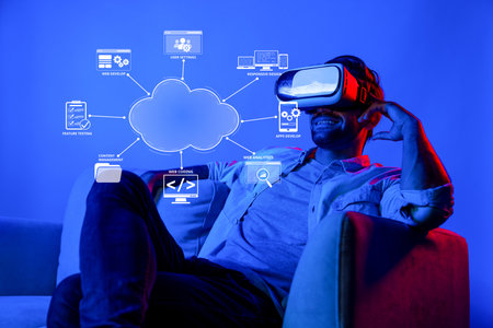 A man enjoys a virtual reality experience related to cloud computing and online development,...