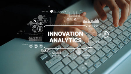 Hands Typing on Keyboard with Overlay of Innovation and Analytics Visual Elements in Modern Office...