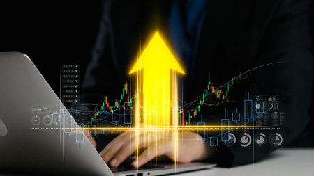 A businessman sits in a modern office with a laptop, analyzing financial market trends. The image...
