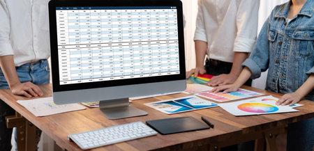 Accounting software on computer screen showing financial statement spreadsheets and account balance...