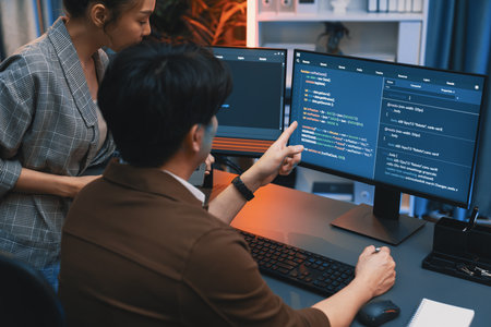 IT developers discussing with point to intelligent website development coder system running data...