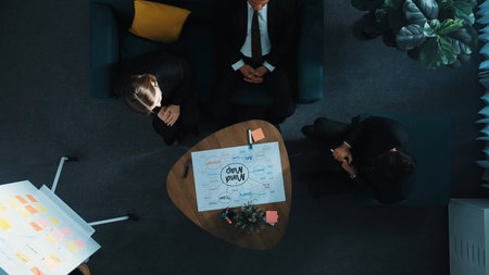Top down aerial view of executive manager writing on whiteboard and sharing marketing strategy....